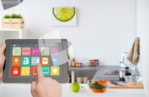 Image of hands with smart home icons on tablet computer