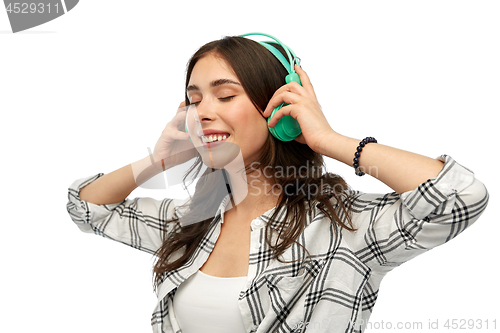 Image of happy young woman or teenage girl with headphones