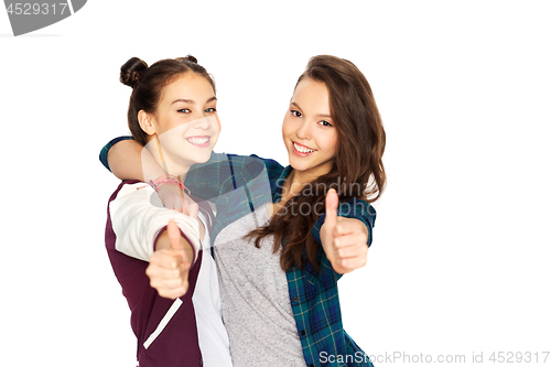 Image of happy teenage girls hugging and showing thumbs up