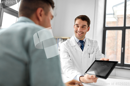 Image of doctor with tablet computer and patient at clinic