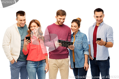 Image of friends with smartphones and tablet computer