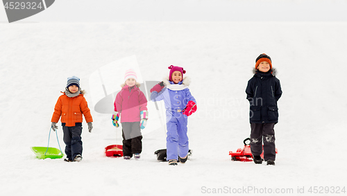 Image of happy little kids with sleds in winter