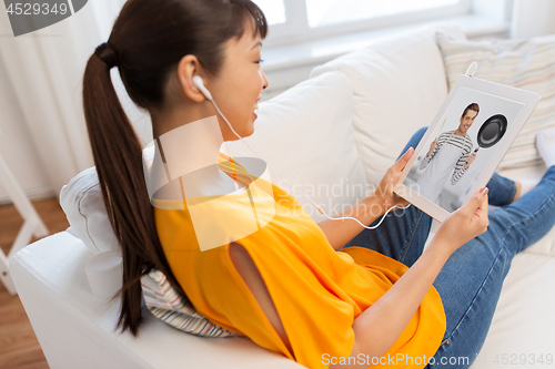 Image of woman watching cooking video on tablet computer