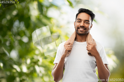 Image of smiling indian man with towel