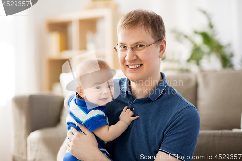 Image of happy baby boy with father at home