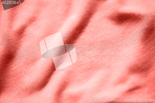 Image of textile or fabric texture in living coral color