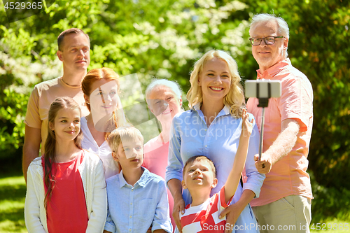 Image of happy family taking selfie in summer garden