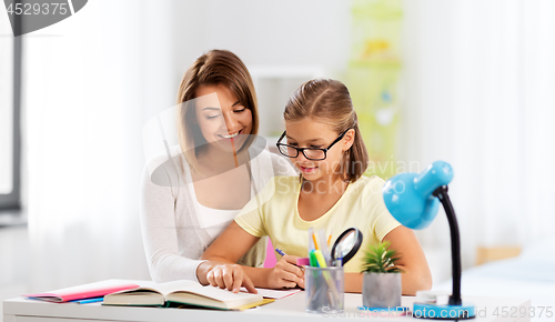 Image of mother and daughter doing homework together