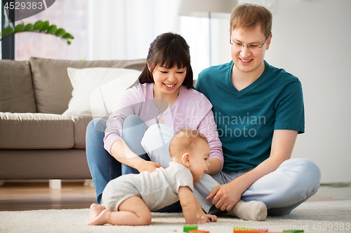 Image of happy mixed race family with baby son at home