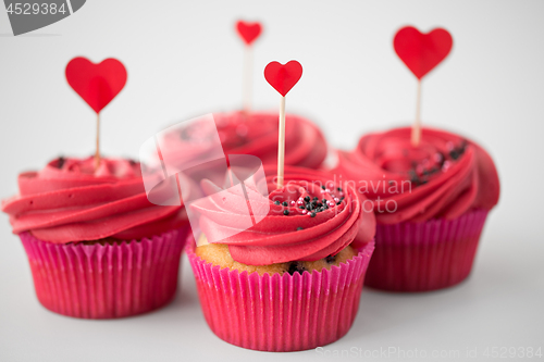 Image of close up of cupcakes with heart cocktail sticks