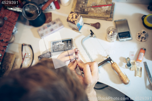 Image of Different goldsmiths tools on the jewelry workplace. Jeweler at work in jewelry.