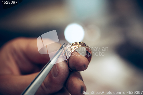 Image of Different goldsmiths tools on the jewelry workplace. Jeweler at work in jewelry.