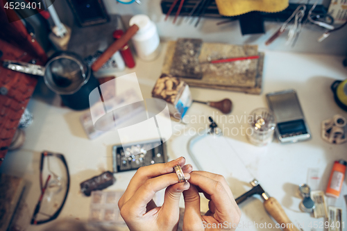 Image of Different goldsmiths tools on the jewelry workplace. Jeweler at work in jewelry.