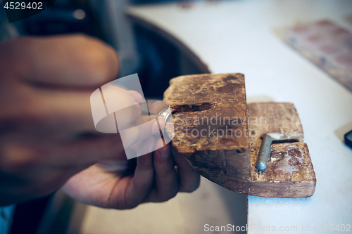 Image of Different goldsmiths tools on the jewelry workplace. Jeweler at work in jewelry.