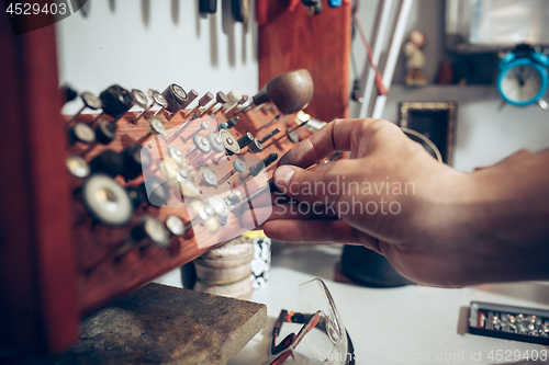 Image of Different goldsmiths tools on the jewelry workplace. Jeweler at work in jewelry.