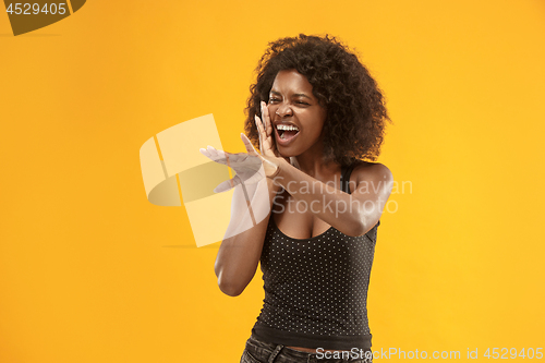 Image of Isolated on red young casual afro woman shouting at studio