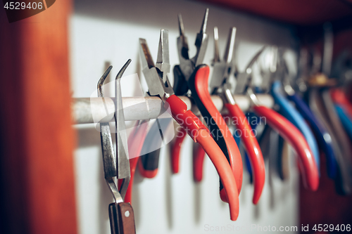 Image of Different goldsmiths tools on the jewelry workplace. work in jewelry.