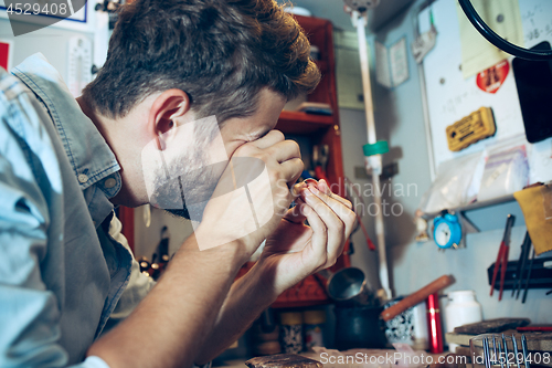 Image of Different goldsmiths tools on the jewelry workplace. Jeweler at work in jewelry.