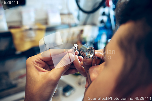 Image of Different goldsmiths tools on the jewelry workplace. Jeweler at work in jewelry.