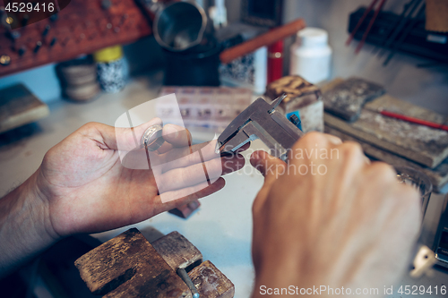 Image of Different goldsmiths tools on the jewelry workplace. Jeweler at work in jewelry.