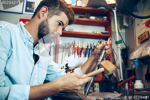 Image of Different goldsmiths tools on the jewelry workplace. Jeweler at work in jewelry.