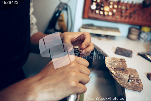 Image of Different goldsmiths tools on the jewelry workplace. Jeweler at work in jewelry.