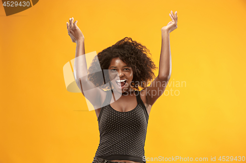 Image of Winning success woman happy ecstatic celebrating being a winner. Dynamic energetic image of female afro model