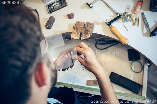 Image of Different goldsmiths tools on the jewelry workplace. Jeweler at work in jewelry.