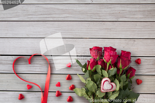 Image of close up of red roses and heart shaped candies