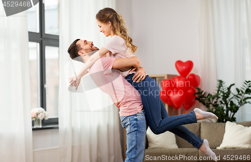 Image of happy couple at home on valentines day