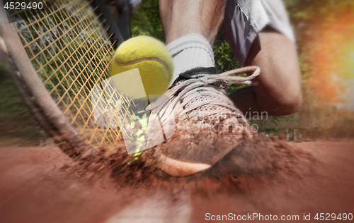 Image of Tennis player on clay tennis court