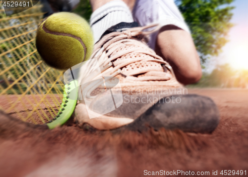 Image of Tennis player on clay tennis court