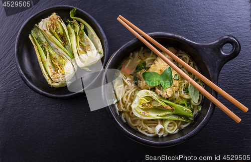 Image of Thai green curry chicken soup with pak choi