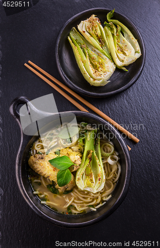 Image of Thai green curry chicken soup with pak choi