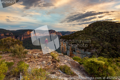 Image of Female takes in the magnificent mountain valley views