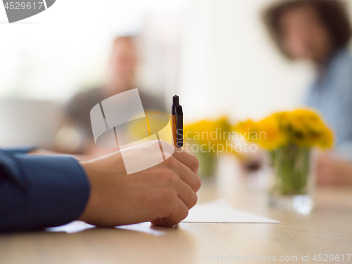 Image of Business man hand holding pen