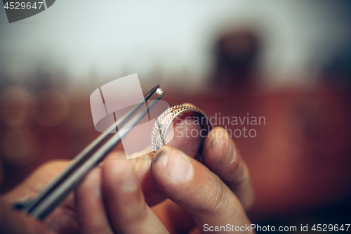 Image of Different goldsmiths tools on the jewelry workplace. Jeweler at work in jewelry.