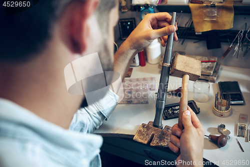 Image of Different goldsmiths tools on the jewelry workplace. Jeweler at work in jewelry.