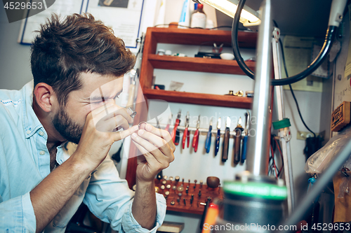 Image of Different goldsmiths tools on the jewelry workplace. Jeweler at work in jewelry.