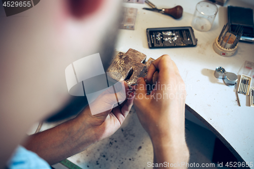 Image of Different goldsmiths tools on the jewelry workplace. Jeweler at work in jewelry.