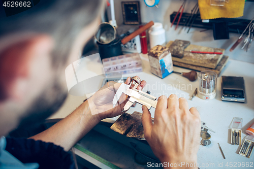 Image of Different goldsmiths tools on the jewelry workplace. Jeweler at work in jewelry.