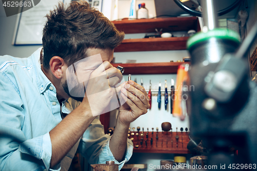 Image of Different goldsmiths tools on the jewelry workplace. Jeweler at work in jewelry.