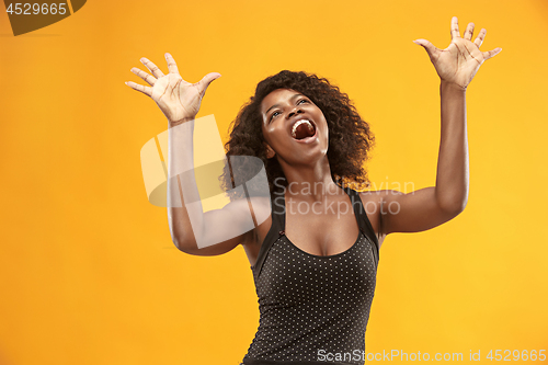 Image of Winning success woman happy ecstatic celebrating being a winner. Dynamic energetic image of female afro model