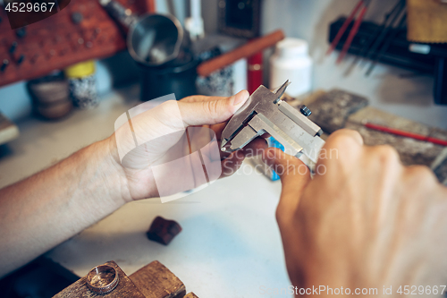 Image of Different goldsmiths tools on the jewelry workplace. Jeweler at work in jewelry.