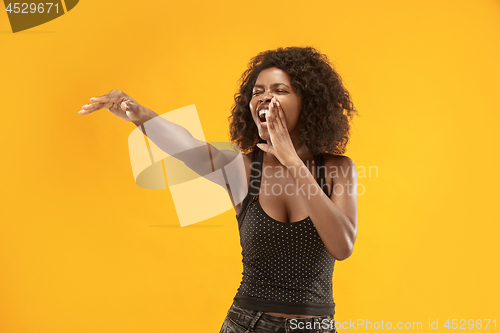 Image of Isolated on red young casual afro woman shouting at studio
