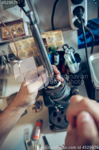 Image of Different goldsmiths tools on the jewelry workplace. Jeweler at work in jewelry.