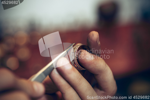 Image of Different goldsmiths tools on the jewelry workplace. Jeweler at work in jewelry.