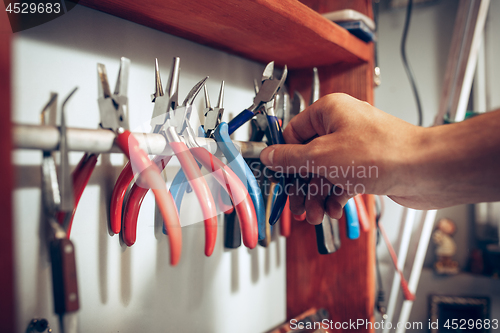 Image of Different goldsmiths tools on the jewelry workplace. work in jewelry.