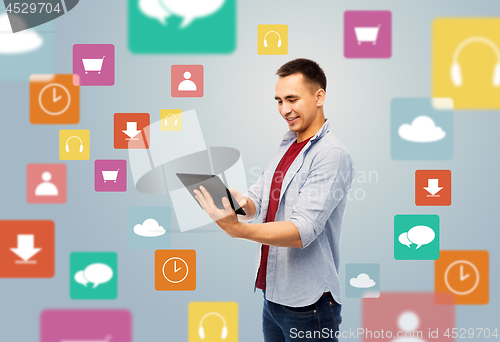 Image of happy young man with tablet over media icons