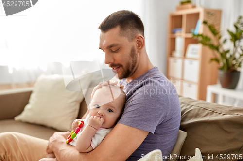 Image of happy father with little baby daughter at home